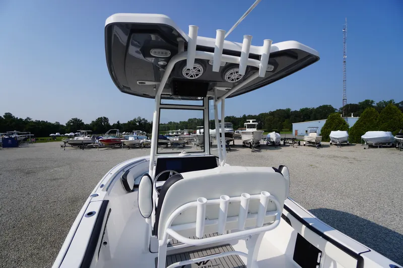 Slide: The Image of 2026 Tidewater 210 CC Adventure boat with T-top and rod holders in a marina setting. - 43