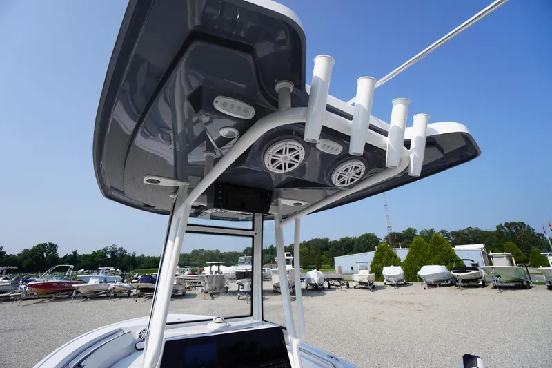 Slide: The Image of Tidewater 210 CC Adventure 2026 boat with T-top and rod holders in a marina setting. - 44