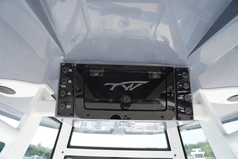Slide: The Image of 2026 Tidewater 210 CC Adventure boat console with control panel and logo. - 46