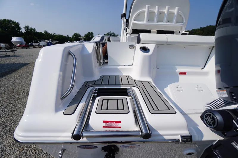 Slide: The Image of 2026 Tidewater 210 CC Adventure boat deck with swim ladder and seating area. - 52
