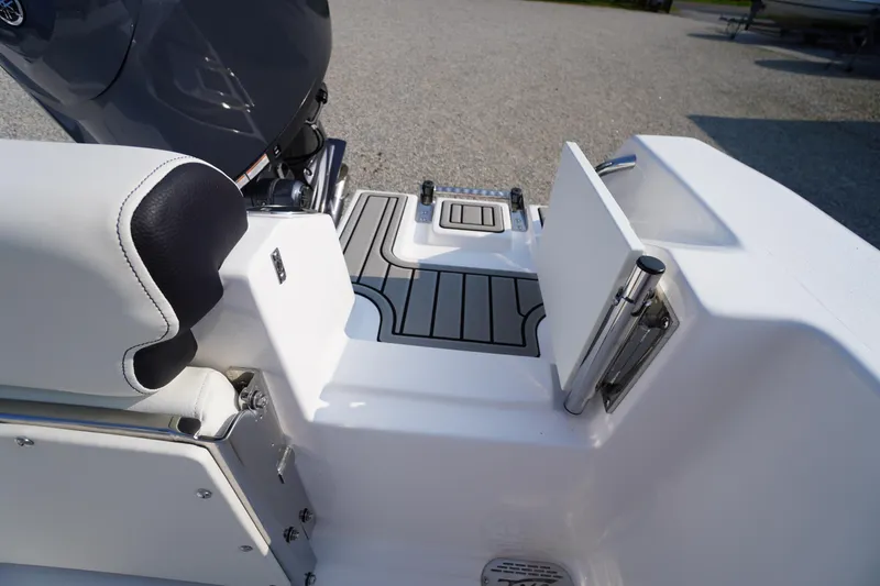 Slide: The Image of 2026 Tidewater 210 CC Adventure boat interior with seating and motor detail. - 54
