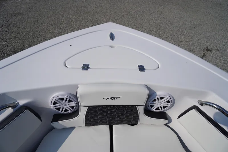 Slide: The Image of 2026 Tidewater 210 CC Adventure boat interior with speakers and cushioned seating. - 6