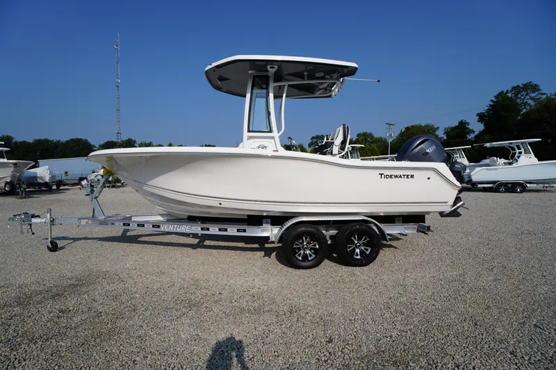 Slide: The Image of 2026 Tidewater 210 CC Adventure boat on trailer, parked on gravel lot. - 60