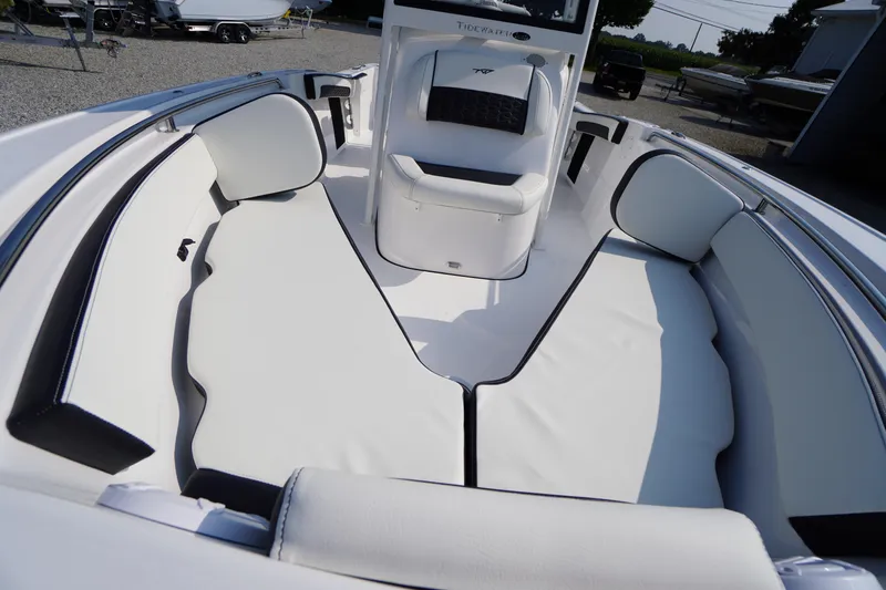 Slide: The Image of 2026 Tidewater 210 CC Adventure boat interior with white cushioned seating. - 9
