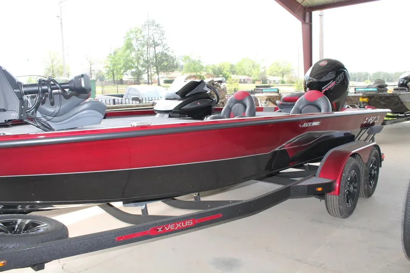 Slide: The Image of 2024 Vexus AVX1980C fishing boat in red and black, parked on a trailer. - 12