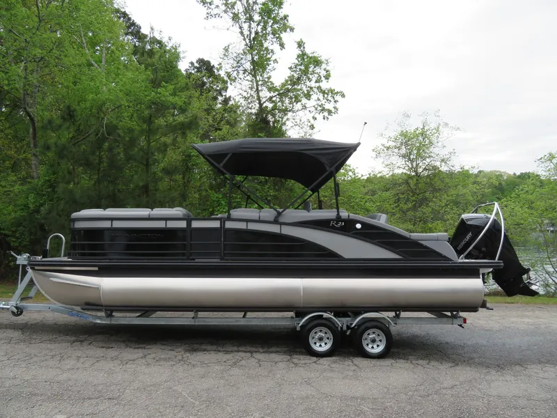 The Image of 2024 Bennington 23RSB pontoon boat on trailer in greenery. - 1