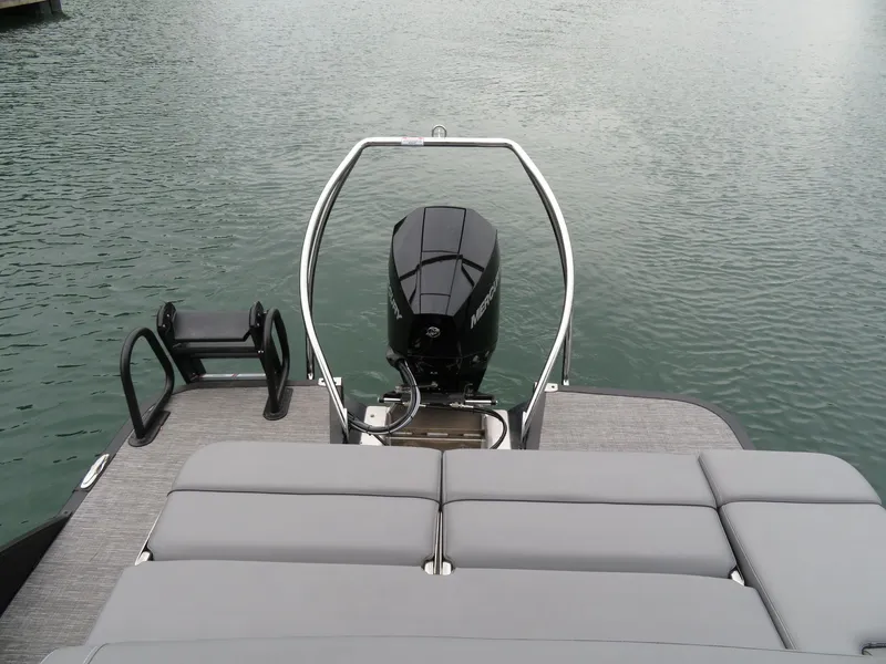 Slide: The Image of 2024 Bennington 23RSB pontoon boat with outboard motor on calm water. - 10