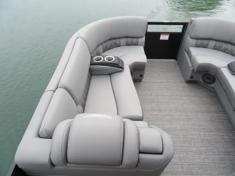 Slide: The Image of Interior of 2024 Bennington 23RSB with gray upholstery and cup holders. - 9