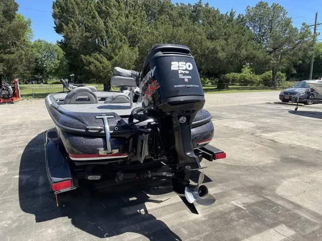 Slide: The Image of 2010 Nitro Z9 boat with Mercury 250 Pro XS engine in a parking lot. - 4