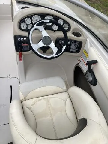 Slide: The Image of 2012 Tahoe Q8SSI boat parked outdoors, featuring sleek design and comfortable seating. - 4