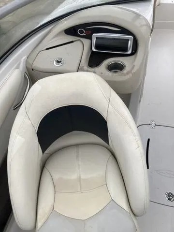 Slide: The Image of 2012 Tahoe Q8SSI boat interior with white seating and dashboard controls. - 8