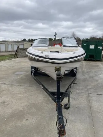 Slide: The Image of 2012 Tahoe Q8SSI boat on trailer, parked outdoors under cloudy skies. - 9