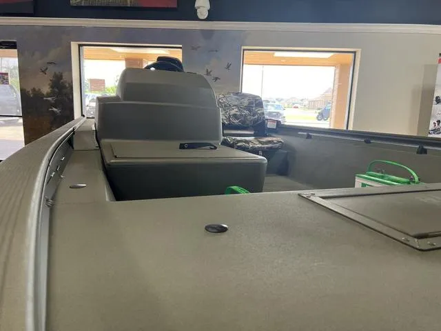 Slide: The Image of 2024 Tracker 1754SC boat on display indoors. - 6