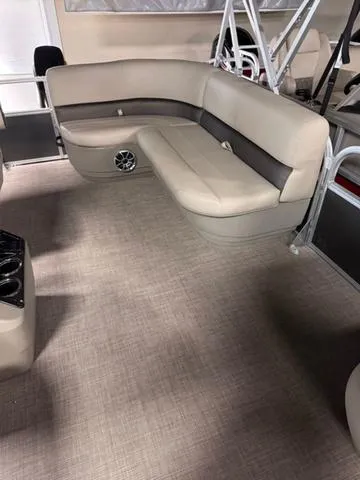 Slide: The Image of 2024 Sun Tracker PARTY BARGE® 16 DLX interior with beige captain's chair and steering console. - 6