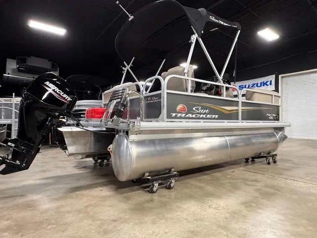 Slide: The Image of 2024 Sun Tracker PARTY BARGE® 16 DLX beige seating with integrated speaker. - 7