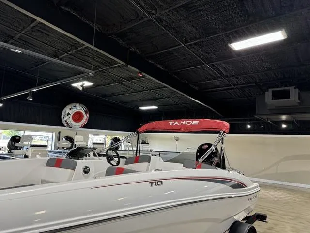Slide: The Image of 2024 Tahoe T18 boat with red canopy in showroom. - 4