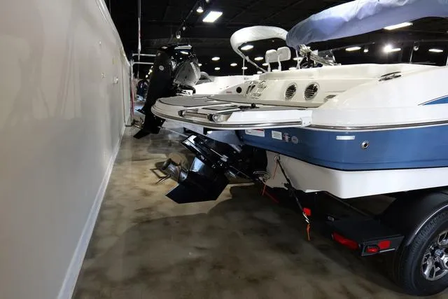 Slide: The Image of 2024 Tahoe TAHOE210SILJ boat on display in showroom, rear view. - 5
