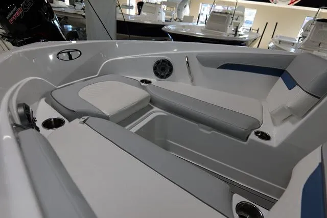 Slide: The Image of 2024 Tahoe TAHOE210SILJ boat interior with cushioned seating and cup holders. - 9