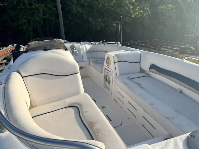 Slide: The Image of 2006 Hurricane 172GS boat interior with white seating and storage compartments. - 2