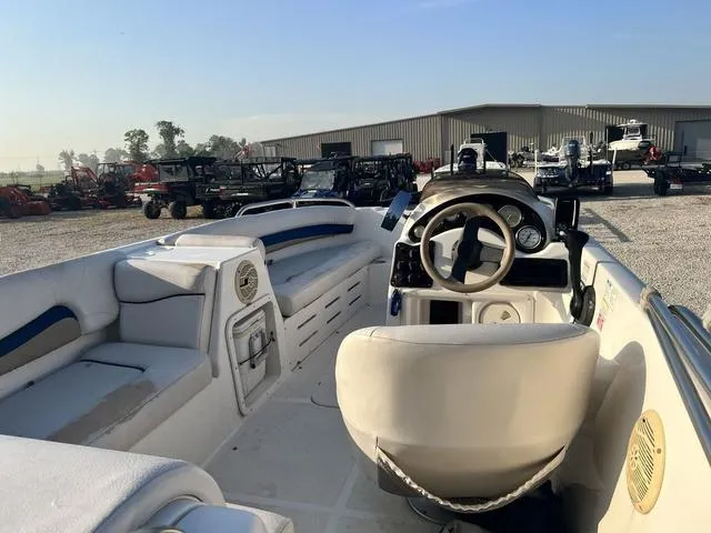 Slide: The Image of Interior of a 2006 Hurricane 172GS boat with steering wheel and seating. - 3