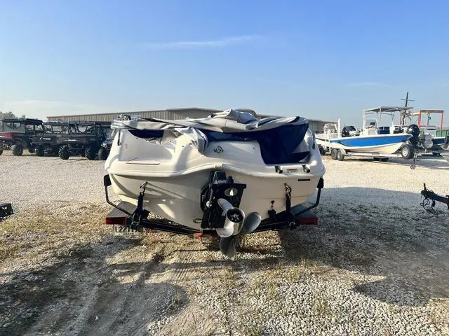 Slide: The Image of 2006 Hurricane 172GS boat on a trailer in a gravel lot. - 5