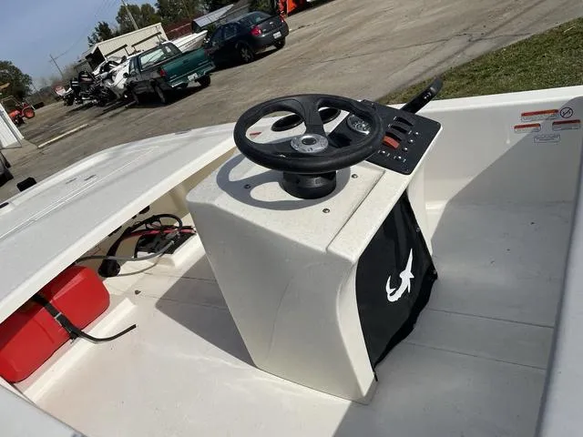 Slide: The Image of 2023 Mako 13CC boat interior with steering console and storage compartment. - 3