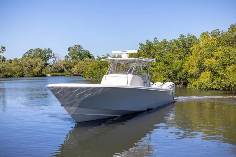 Slide: The Image of 2021 Contender 39FA Fish Around boat cruising on a calm river. - 11