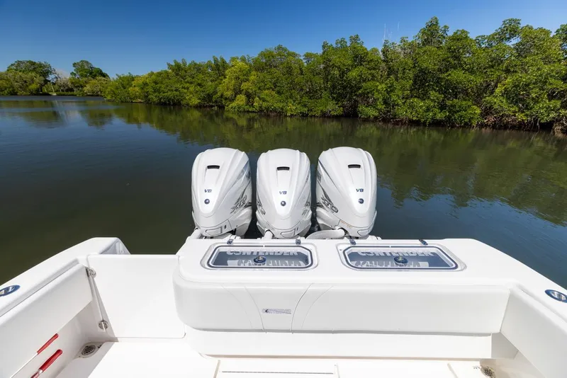 Slide: The Image of 2021 Contender 39FA Fish Around with triple outboard engines on a calm river. - 13