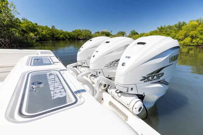 Slide: The Image of 2021 Contender 39FA Fish Around with triple Yamaha XTO engines on a calm river. - 14