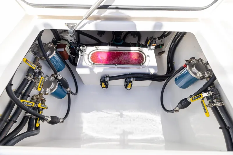Slide: The Image of 2021 Contender 39FA Fish Around boat engine compartment with fuel filters and hoses. - 17