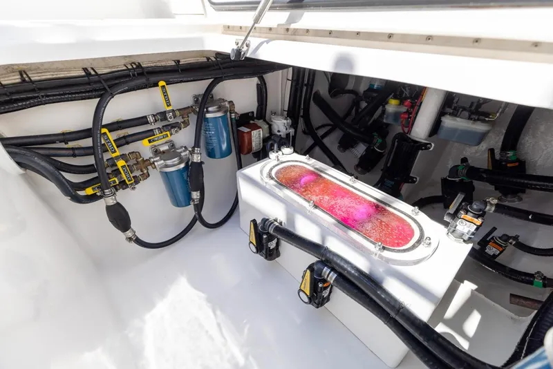 Slide: The Image of 2021 Contender 39FA Fish Around boat engine compartment with fuel filters and wiring. - 18