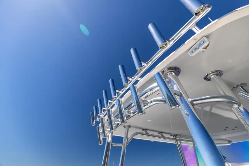 Slide: The Image of 2021 Contender 39FA Fish Around boat, rod holders against clear blue sky. - 22