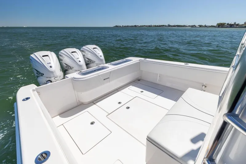 Slide: The Image of 2021 Contender 39FA Fish Around boat with triple outboard engines on open water. - 38