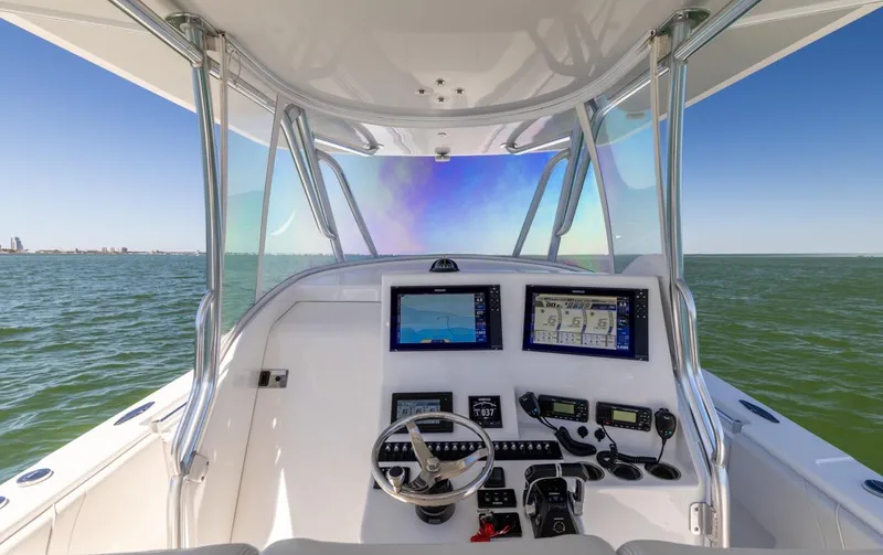 Slide: The Image of 2021 Contender 39FA Fish Around boat cockpit with navigation screens and steering wheel. - 46