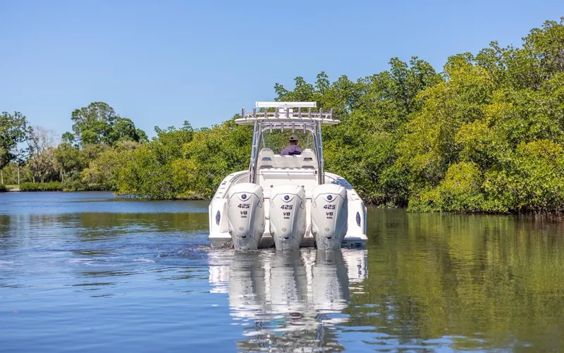 Slide: The Image of 2021 Contender 39FA Fish Around boat cruising on a calm river. - 6