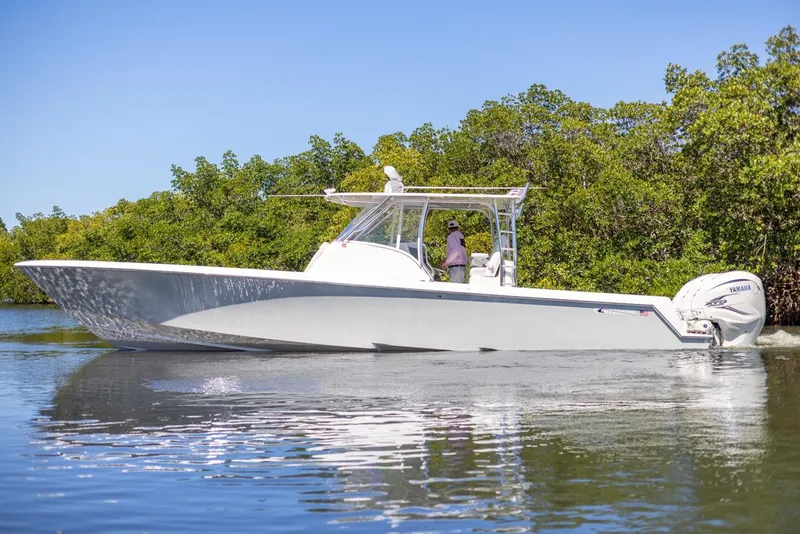 Slide: The Image of 2021 Contender 39FA Fish Around boat cruising on a calm waterway. - 9