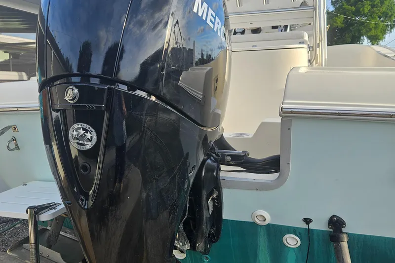 Slide: The Image of 2014 Key Largo 2100 boat with Mercury outboard motor, docked and ready for use. - 12