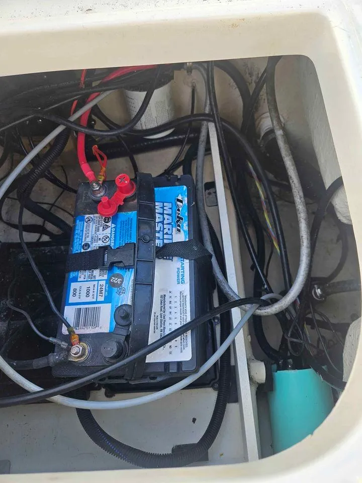 Slide: The Image of Boat battery compartment with wiring in a 2014 Key Largo 2100 model. - 17