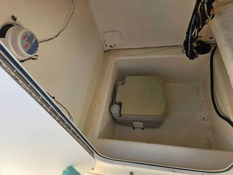 Slide: The Image of Key Largo 2100 boat storage compartment with portable toilet, 2014 model. - 24