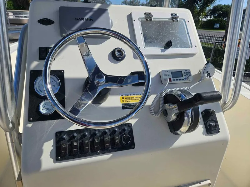 Slide: The Image of Key Largo 2100 boat dashboard with steering wheel and controls, 2014 model. - 25