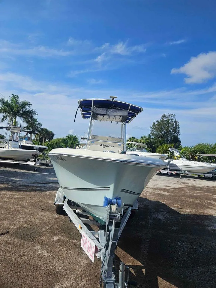 Slide: The Image of 2014 Key Largo 2100 boat on trailer under clear blue sky. - 27