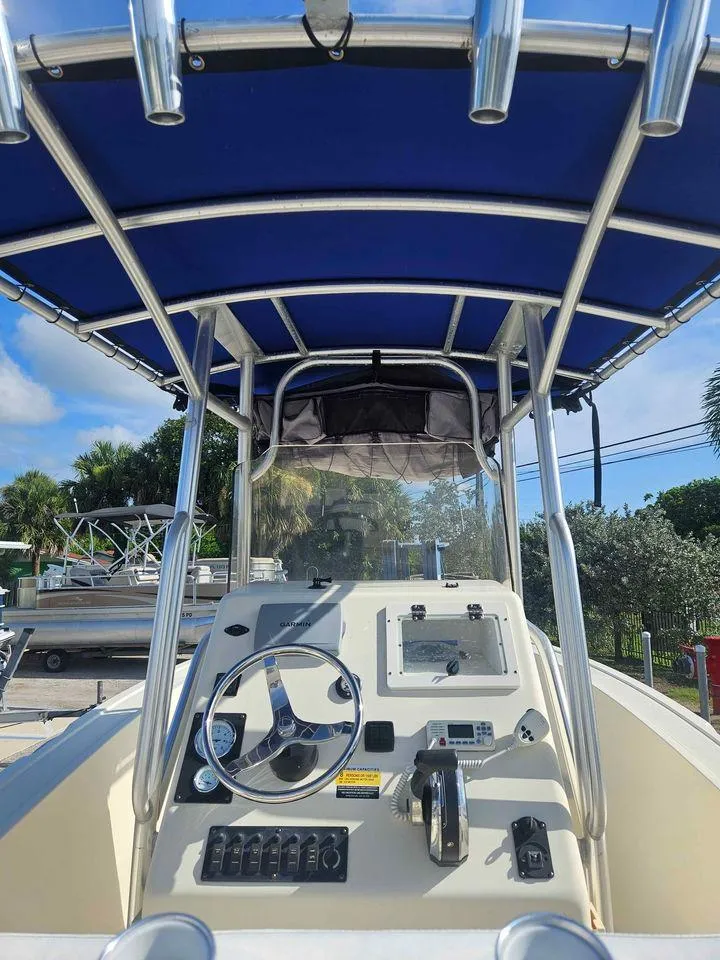 Slide: The Image of 2014 Key Largo 2100 boat console with blue canopy and steering wheel. - 3