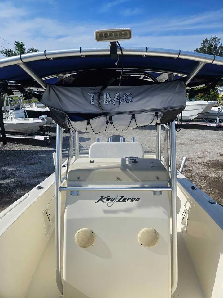 Slide: The Image of 2014 Key Largo 2100 boat with T-top and T-Bag storage, docked outdoors. - 4