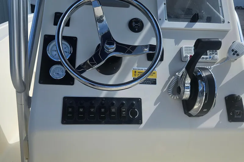 Slide: The Image of Key Largo 2100 boat dashboard with steering wheel and controls, 2014 model. - 6