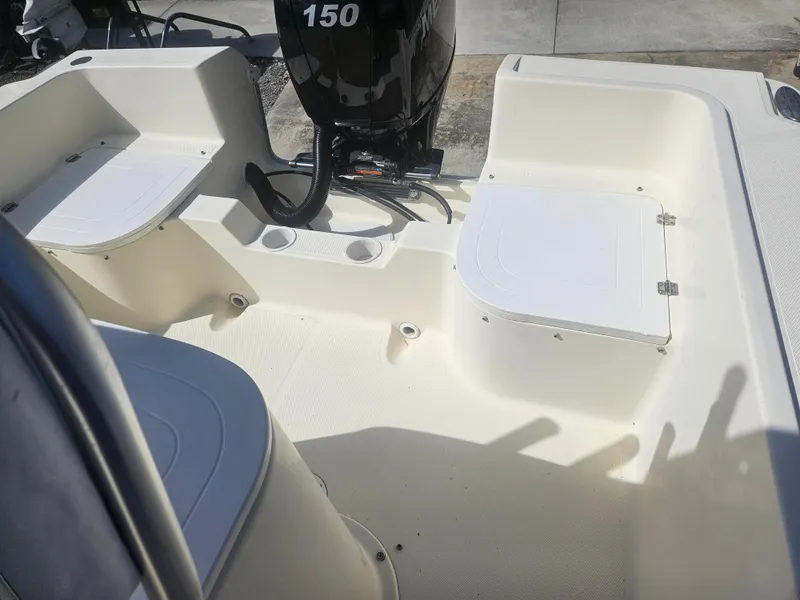 Slide: The Image of 2014 Key Largo 2100 boat interior with seating and 150 HP outboard motor. - 7