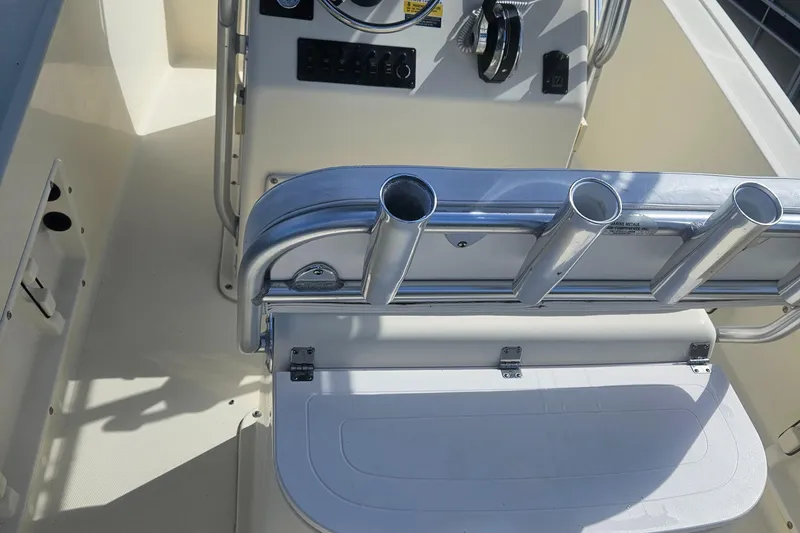 Slide: The Image of 2014 Key Largo 2100 boat interior with rod holders and control panel. - 8