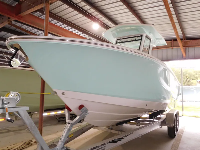 Slide: The Image of 2024 Robalo R 250 Center Console boat on trailer in covered storage. - 3