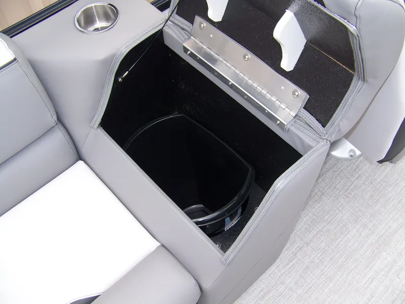 Slide: The Image of 2024 Avalon VENTURE 85 QL boat storage compartment with cup holder and trash bin. - 11