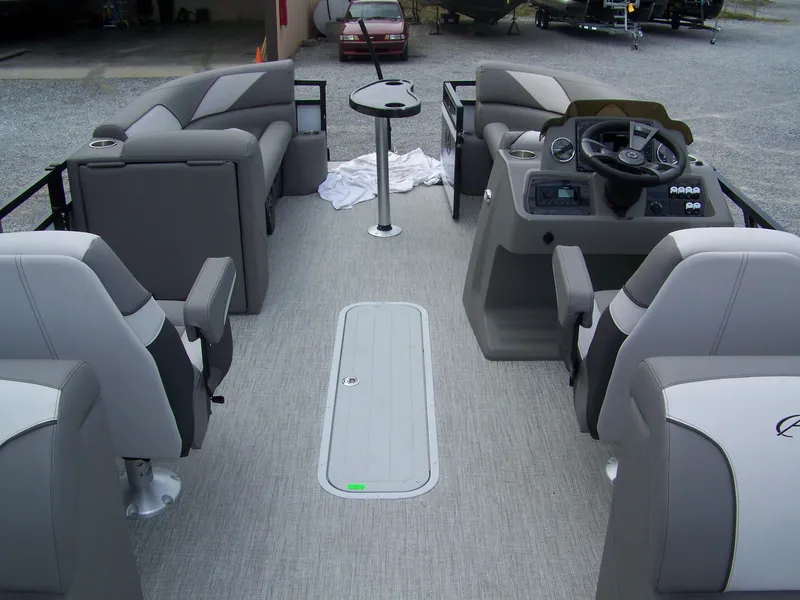 Slide: The Image of 2024 Avalon VENTURE 85 QL pontoon boat interior with gray seating and modern dashboard. - 13