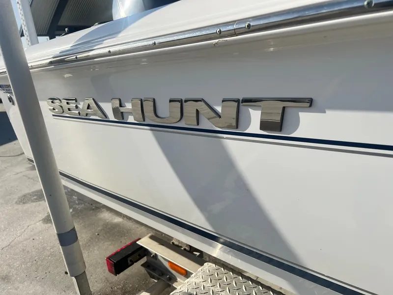 Slide: The Image of 2013 Sea Hunt BX 22 Pro boat side view with logo. - 2